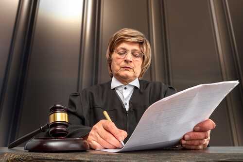 Judge,Signing,The,Verdict.,Judge's,Gavel,On,The,Table,In