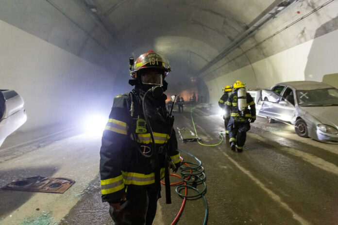Car,Accident,Scene,Inside,A,Tunnel,,Firefighters,Rescuing,People,From