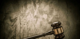 Judges gavel on a dark wooden surface.