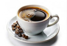 Cup of coffee with coffee beans on saucer