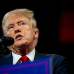 Man speaking at a podium with microphone