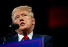 Man speaking at a podium with microphone