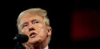 Man speaking at a podium with microphone