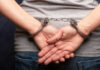 Persons hands in handcuffs behind their back