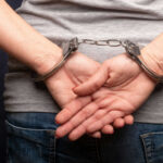 Persons hands in handcuffs behind their back