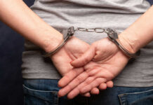 Persons hands in handcuffs behind their back