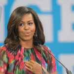 Woman speaking at a podium in colorful dress