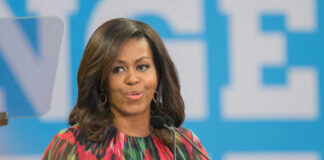 Woman speaking at a podium in colorful dress
