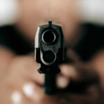 Gun barrel pointed directly at the camera