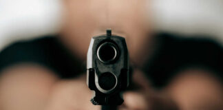 Gun barrel pointed directly at the camera