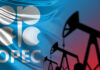 OPEC logo in front of an abstract flag background with oil rigs silhouettes