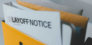 A yellow folder containing a layoff notice and other documents