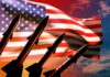 Silhouette of missiles in front of an American flag