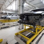 Car frames on an assembly line in a manufacturing facility