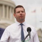 Swalwell TARGETED: FBI’s Controversial Old Files A politician speaking at a press conference outdoors with a microphone