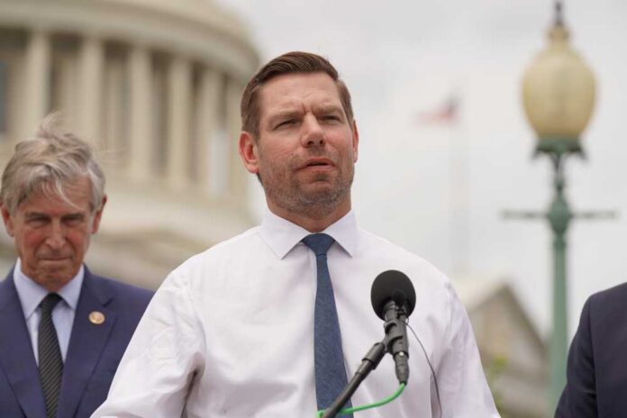 A politician speaking at a press conference outdoors with a microphone
