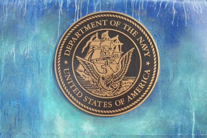 Bronze seal of the Department of the Navy against a blue background