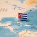 Map of the Caribbean with a small Cuban flag pinned on Cuba