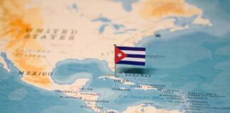 Map of the Caribbean with a small Cuban flag pinned on Cuba