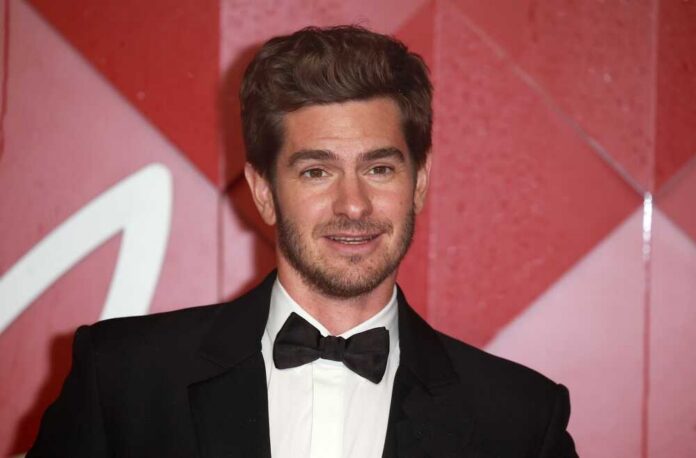shutterstock_2397725815.jpg Andrew Garfield smiling at a red carpet event in formal attire