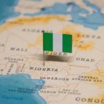 A small Nigerian flag placed on a map highlighting Nigeria