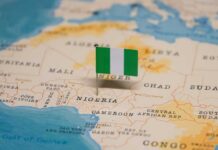A small Nigerian flag placed on a map highlighting Nigeria