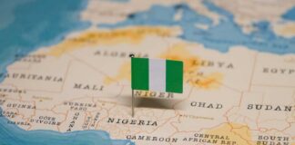 A small Nigerian flag placed on a map highlighting Nigeria
