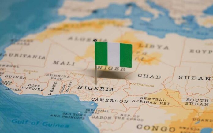 A small Nigerian flag placed on a map highlighting Nigeria
