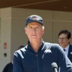 Politician speaking at a press conference outdoors