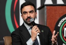 A man speaking into a microphone at a conference