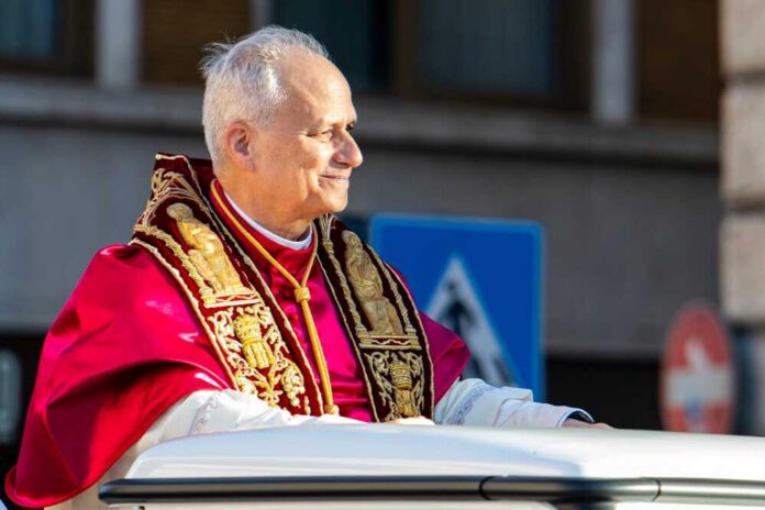 A religious leader in ceremonial attire smiling during a public appearance