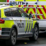 A police car parked next to an emergency vehicle with reflective markings