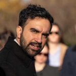 A man speaking passionately to a group of people outdoors