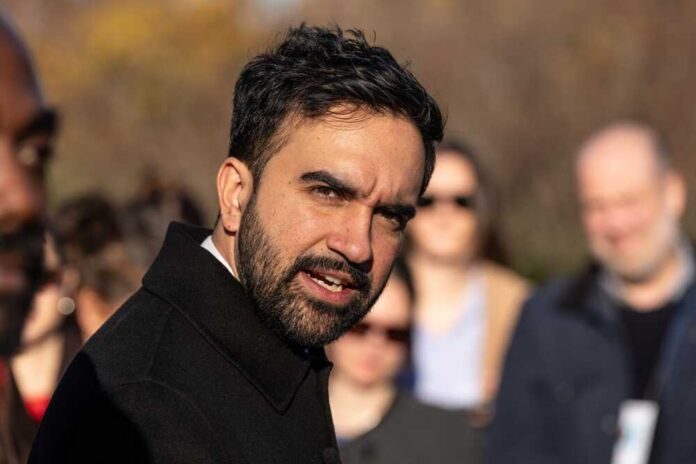 shutterstock_2706098681.jpg A man speaking passionately to a group of people outdoors