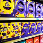 Shelves displaying various Cadbury chocolate products including Mini Eggs and Twirl