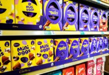 Shelves displaying various Cadbury chocolate products including Mini Eggs and Twirl