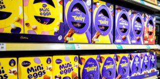 Shelves displaying various Cadbury chocolate products including Mini Eggs and Twirl