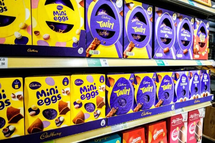 Shelves displaying various Cadbury chocolate products including Mini Eggs and Twirl