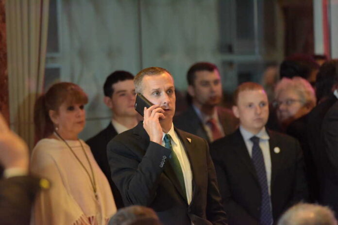 Man in a suit making a phone call at a crowded event
