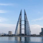 Twin towers in Bahrain against a city skyline