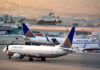 Airplanes parked at airport terminal with United branding