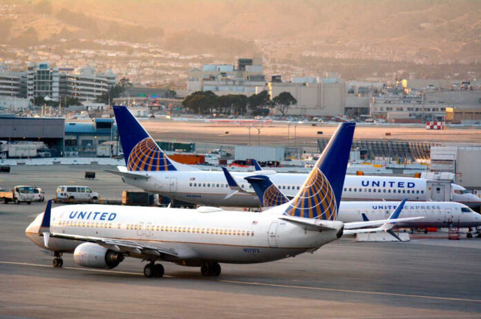 Airplanes parked at airport terminal with United branding