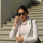 Luna WARNINGS: Unprecedented Housecleaning Looms Person in white jacket talking on phone, wearing sunglasses.