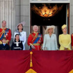 Group of people on a balcony in formal attire