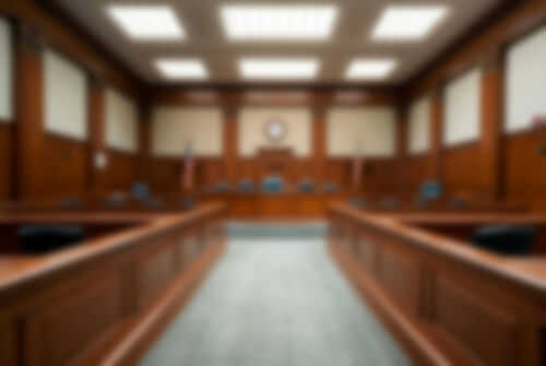 Blurred view of a courtroom with wooden furnishings
