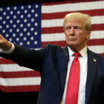 Man pointing with American flag in background