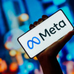 EU’s Meta Blockade: A Threat to U.S. Tech? Hand holding smartphone displaying Meta logo