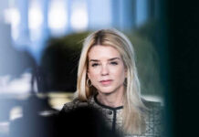 Woman with long blonde hair wearing hoop earrings