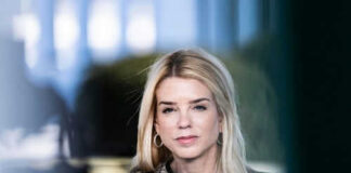 Woman with long blonde hair wearing hoop earrings