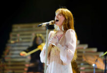 A female singer passionately performing on stage with a microphone